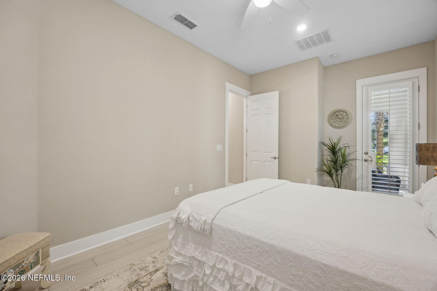 Primary bedroom sitting area with courtyard light