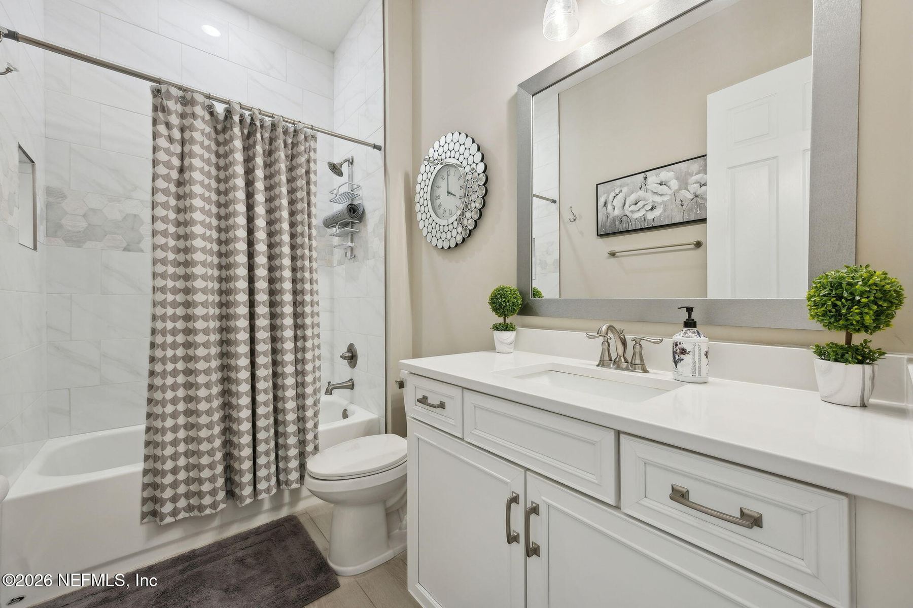 Primary bathroom vanity with marble-look counters