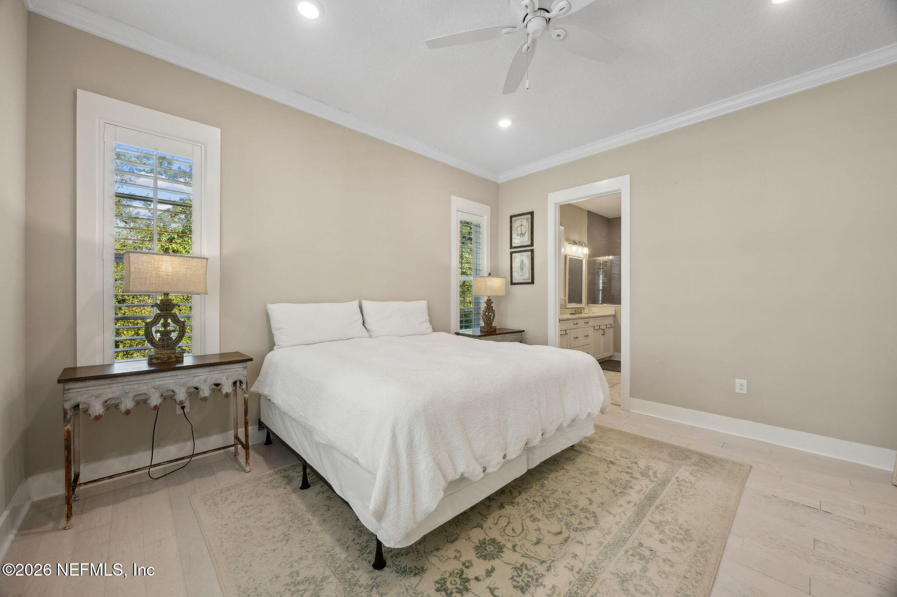 Bedroom with plantation shutters and ceiling fan